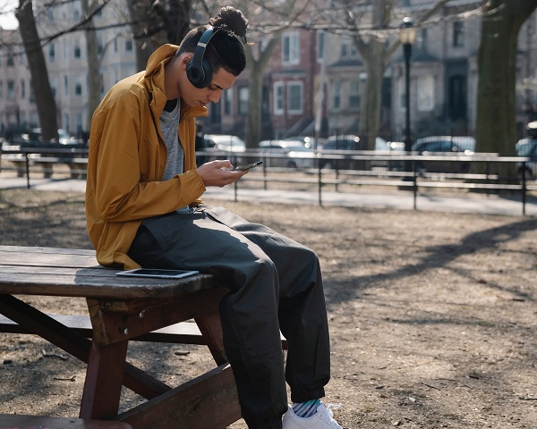 A man using his phone to create music